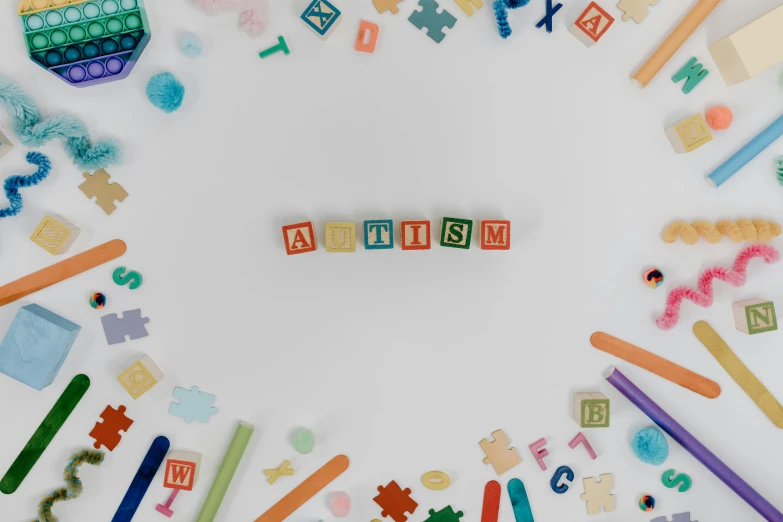 a white table topped with lots of children's toys, trending on pexels, letterism, background image, blocks, colorful medical equipment, ad image