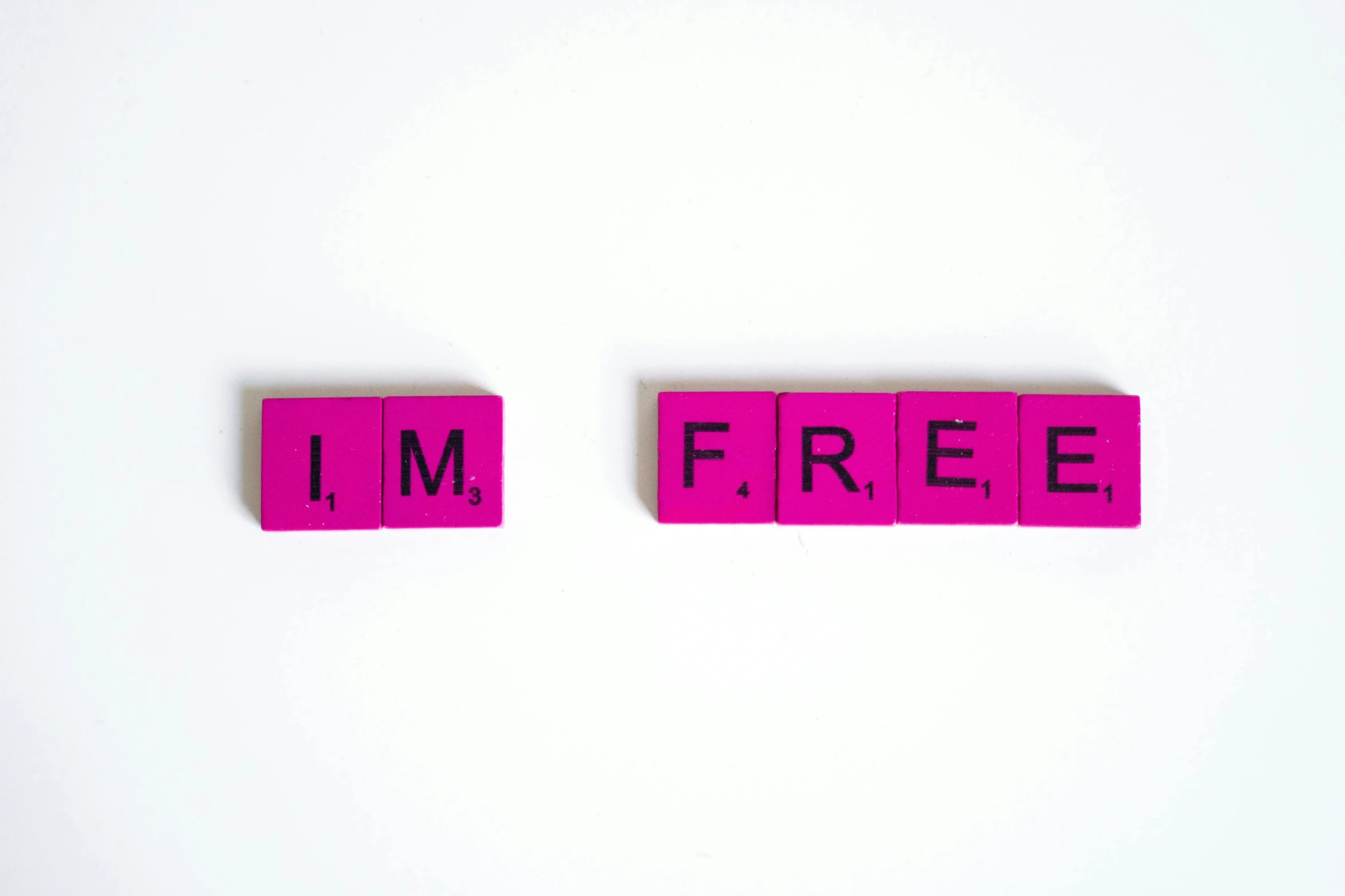 pink scrabbles spelling i'm free on a white surface, a picture, pexels, avatar image, freedom, adafruit, bruce kaiser