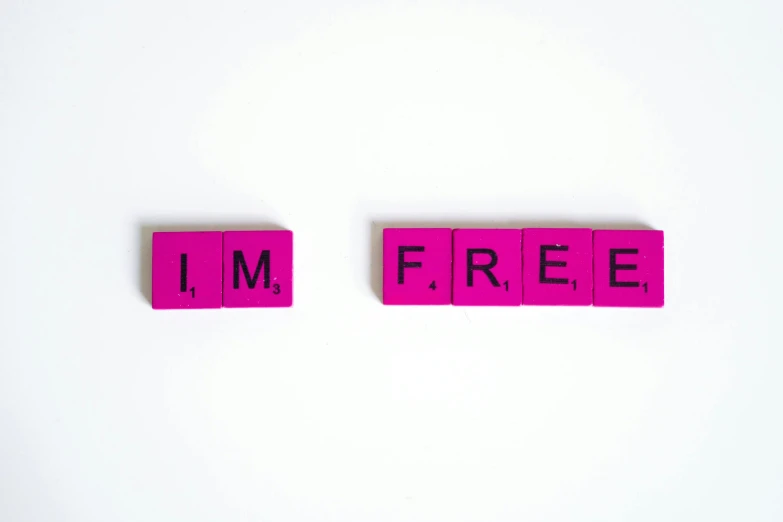 pink scrabbles spelling i'm free on a white surface, a picture, pexels, avatar image, freedom, adafruit, bruce kaiser