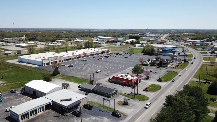 an aerial view of a large parking lot, walton's five and dime, village square, exterior photo, 8 k 4 k