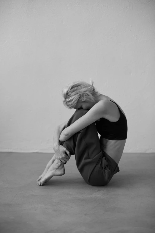 a black and white photo of a woman sitting on the floor, tumblr, minimalism, beth cavener, ffffound, dance meditation, woman very tired