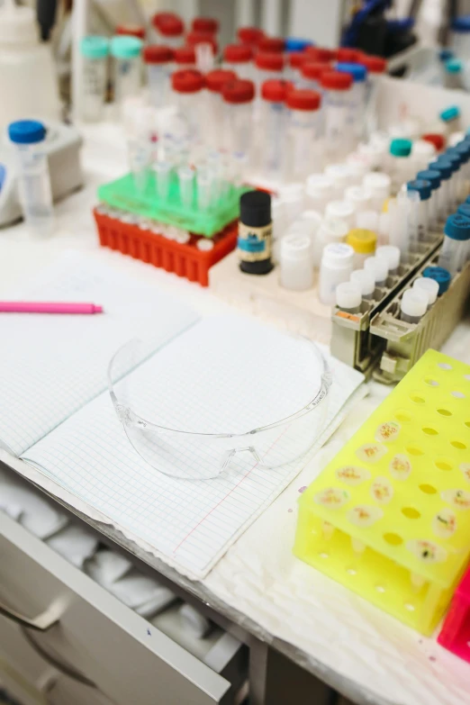 a laboratory table filled with lots of laboratory supplies, by Rachel Reckitt, dna experiment, a wide shot, coloured, white