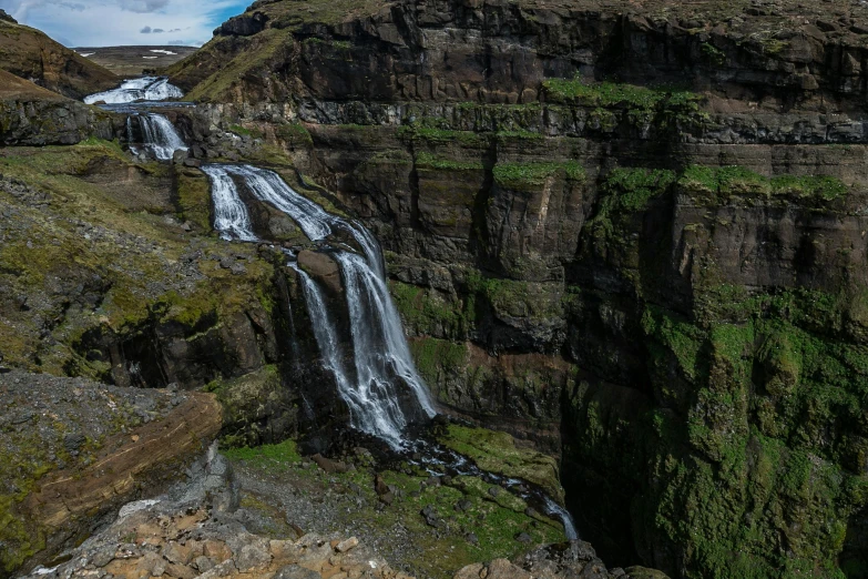 a group of people standing on top of a cliff next to a waterfall, by Hallsteinn Sigurðsson, hurufiyya, beautiful panoramic imagery, high details!, gigapixel photo, multiple stories