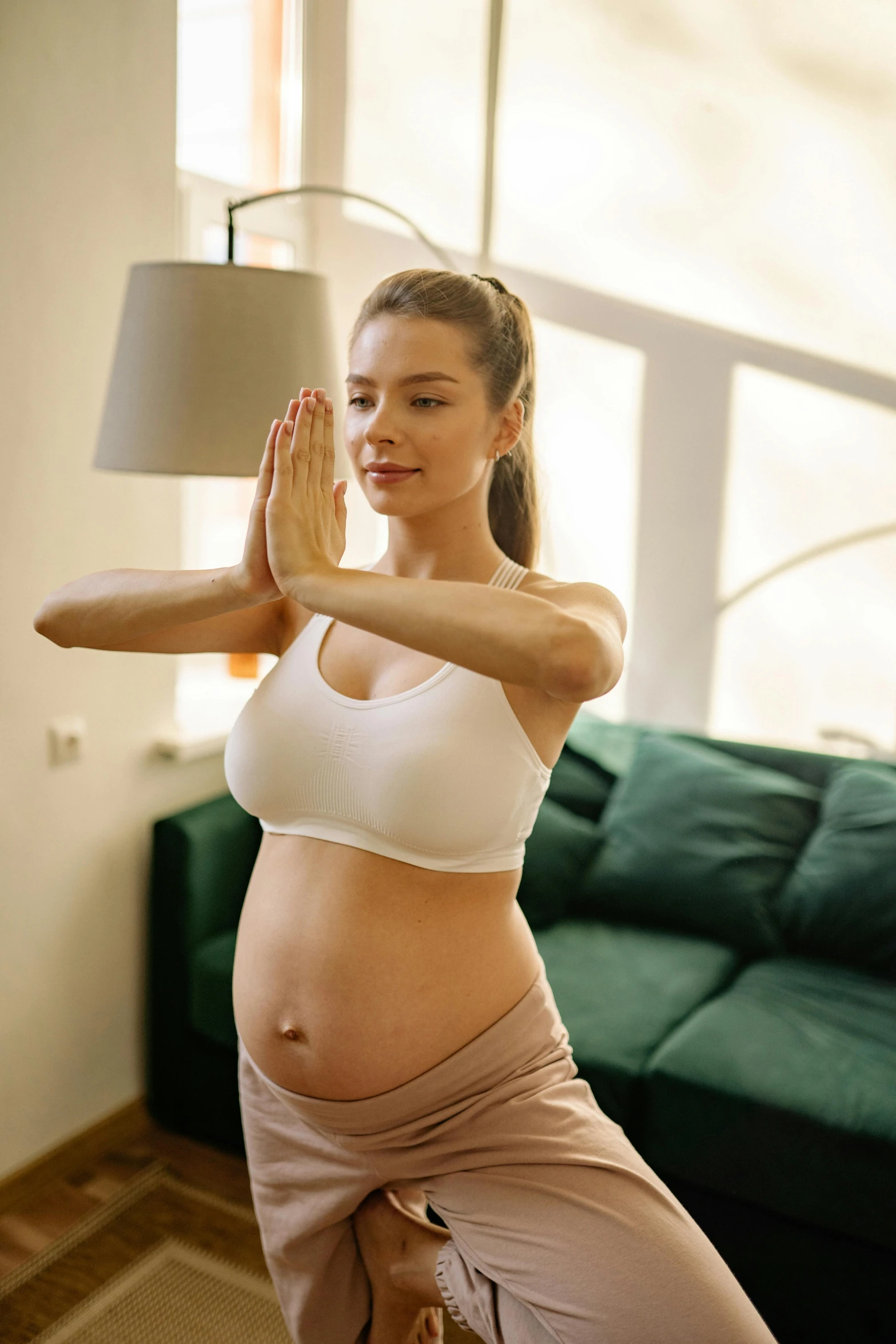 a pregnant woman doing yoga in a living room, by Adam Marczyński, shutterstock, figuration libre, perfect body face and hands, square, raising an arm, lights
