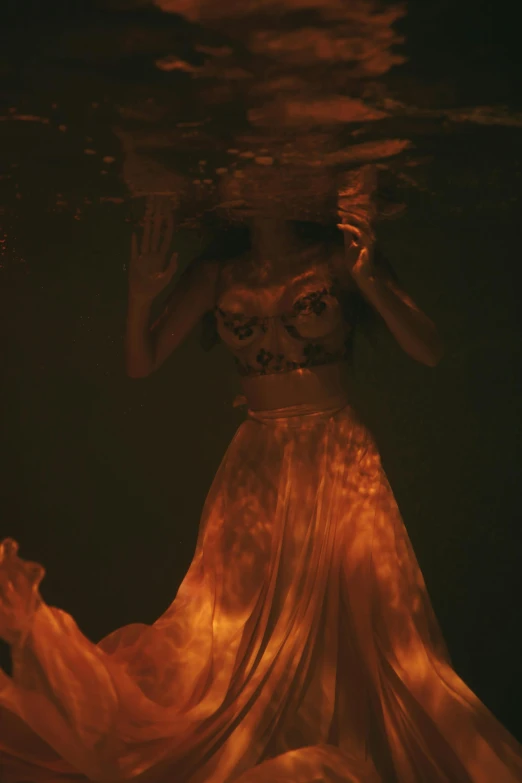 a woman in a long dress under water, an album cover, inspired by Elsa Bleda, her body made of flames, photograph taken in 2 0 2 0, ( ( theatrical ) ), hollow