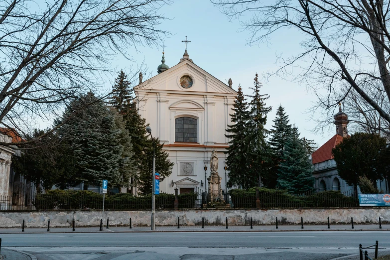 a large white church sitting on the side of a road, inspired by Károly Markó the Elder, pexels contest winner, danube school, square, warsaw, exterior photo, street elevation