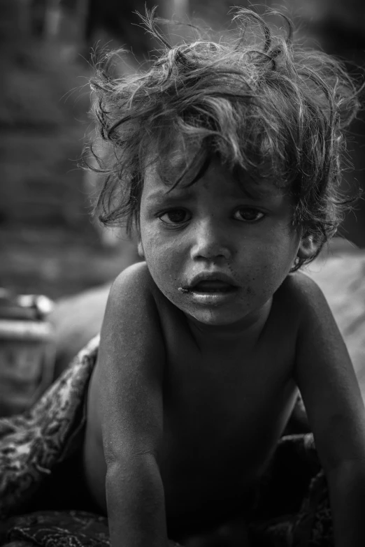 a black and white photo of a child, by irakli nadar, pexels contest winner, a photo of a disheveled man, hunger, innocent look. rich vivid colors, uploaded