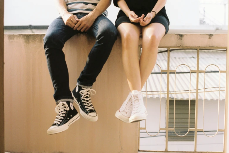 a man and a woman sitting on a balcony, trending on pexels, white shoes, teenage, tall thin, teenager hangout spot