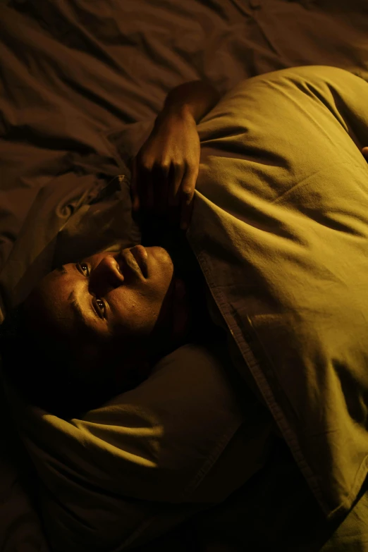 a man laying on top of a bed under a blanket, happening, dark skin, movie still of a snarling, obunga, promo image
