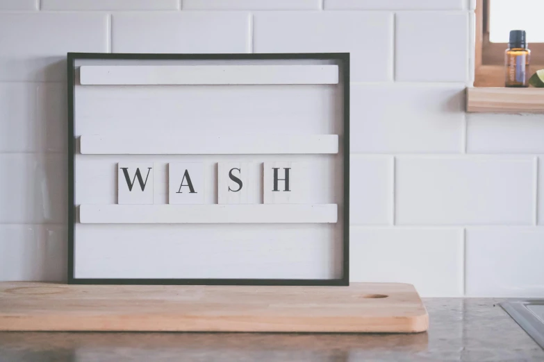 a wooden cutting board sitting on top of a counter, a silk screen, by Sylvia Wishart, unsplash, minimalism, wash, white frame, bath like style, whitewashed housed