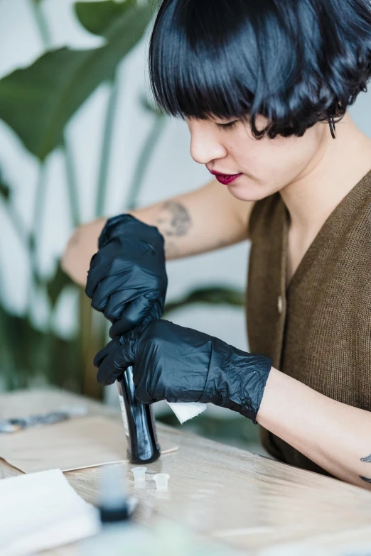 a woman in a brown shirt and black gloves, a charcoal drawing, trending on pexels, lacquerware, asian female, surgery, inking