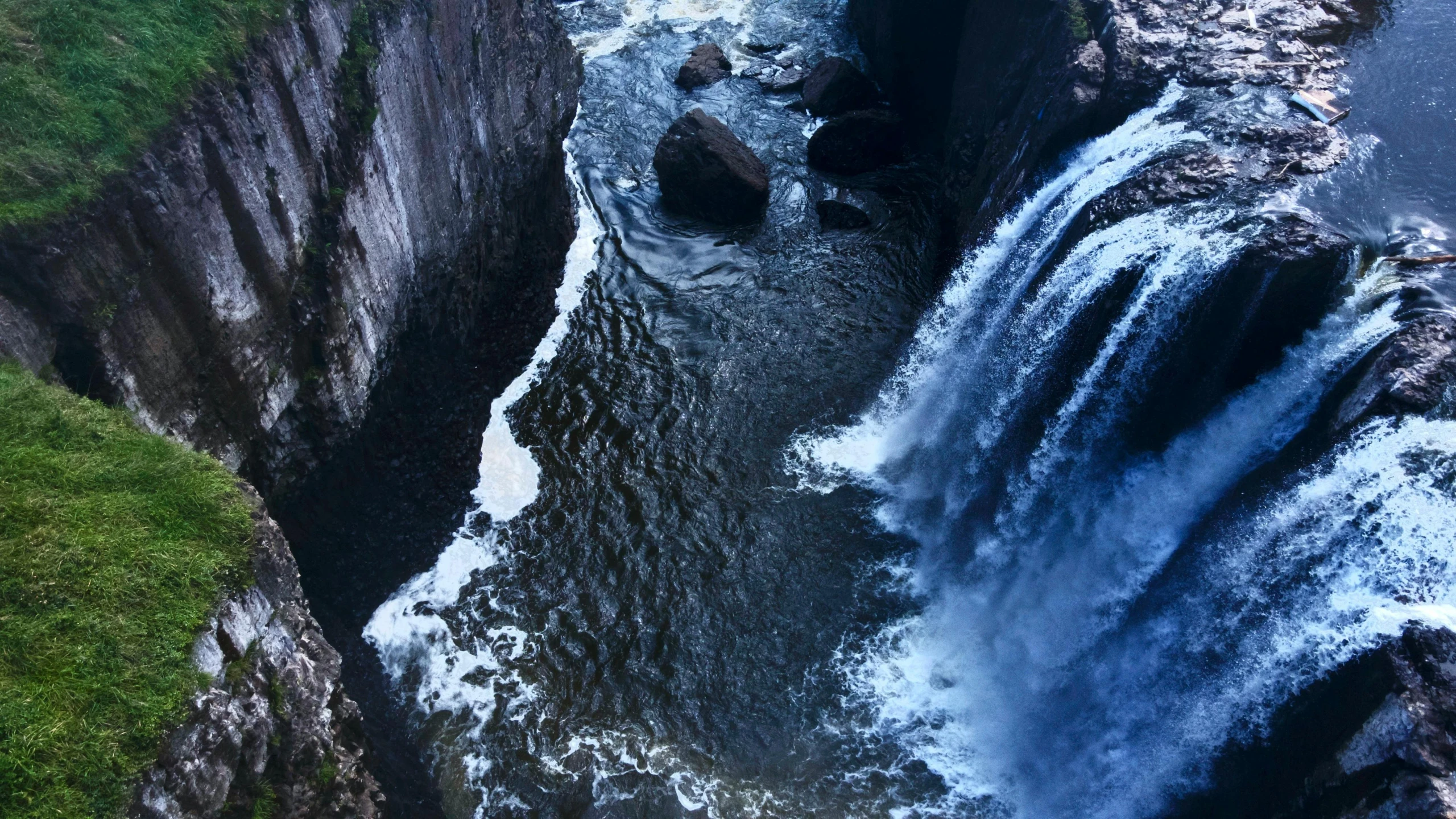 a large waterfall flowing through a lush green forest, an album cover, pexels contest winner, hurufiyya, high view, deep chasm, blue, thumbnail