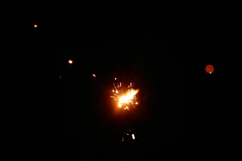 a close up of a firework in the dark, a picture, flickr, taken on iphone 14 pro, car shot, candid photograph, very poor quality of photography