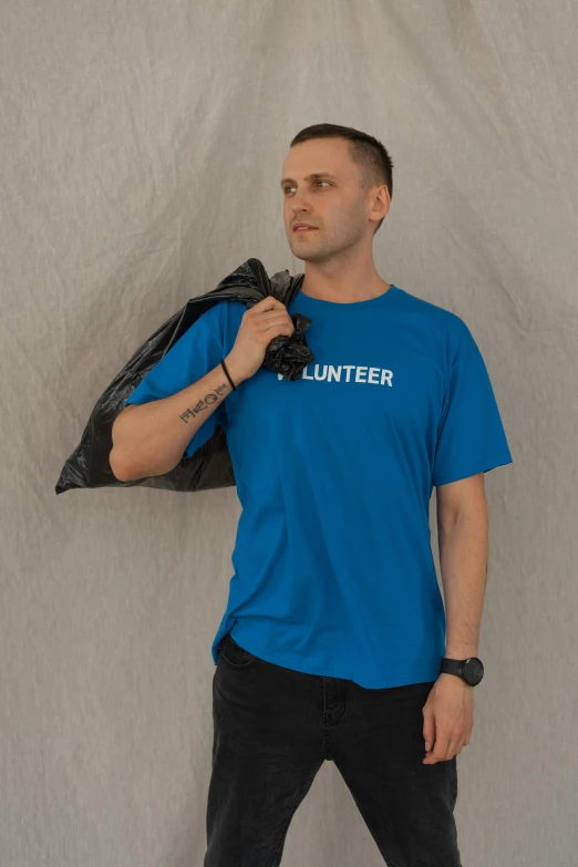 a man in a blue shirt and black pants, inspired by Jan Müller, pexels contest winner, hurufiyya, in tshirt, shelter, product introduction photo, bright blue