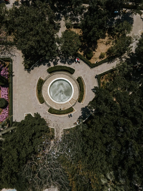 an aerial view of a fountain surrounded by trees, by Alejandro Obregón, unsplash contest winner, 4k photo gigapixel, helipad, flowers inside of a marble, 2 0 0 0's photo