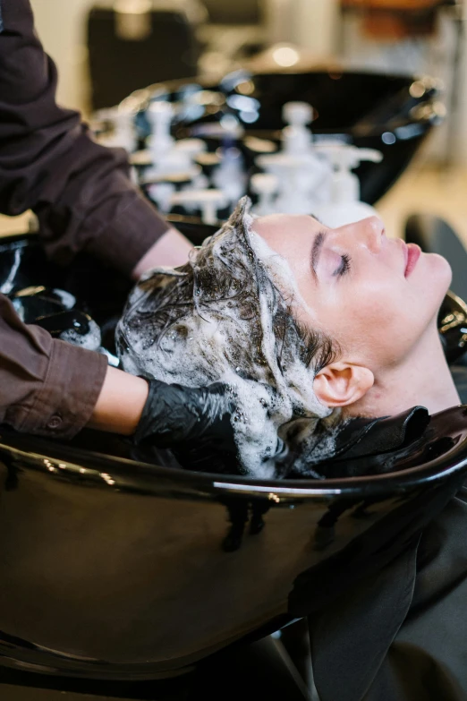 a woman getting her hair washed in a salon, fan favorite, thumbnail, high textured, esthetic