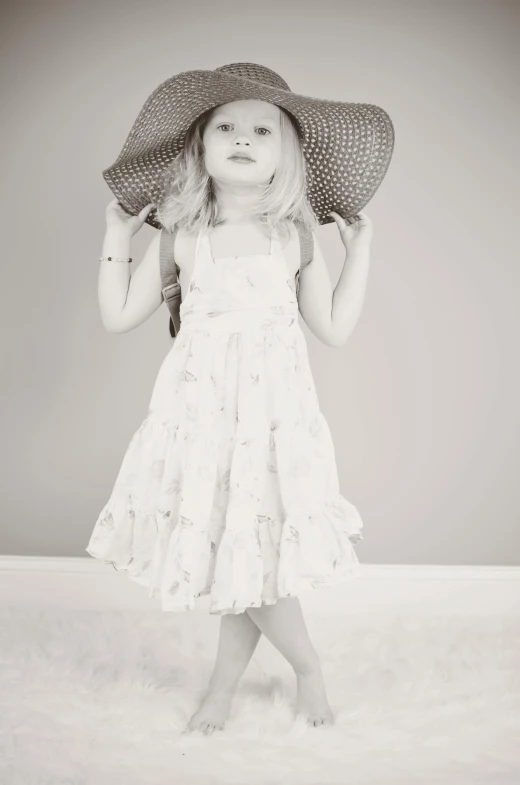 a black and white photo of a little girl wearing a hat, art photography, wearing in a summer dress, pr shoot, monochrome:-2, lux