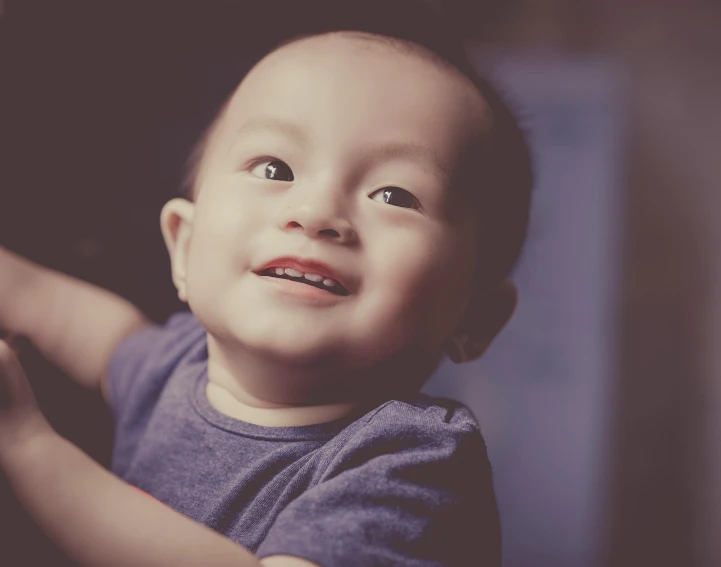 a close up of a child holding a remote control, inspired by Chen Daofu, pexels contest winner, portrait of a smiling, soft light.4k, asian male, profile picture 1024px