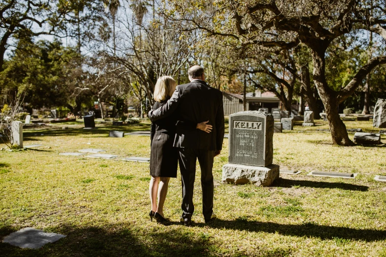 a man and woman standing next to each other in a cemetery, unsplash, sydney hanson, with his back turned, 15081959 21121991 01012000 4k, 4 0 years