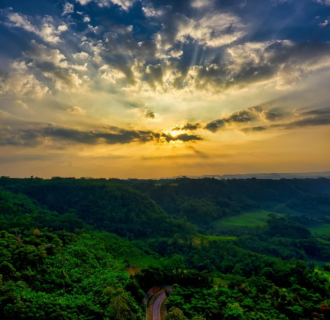 the sun is setting over the green hills, by Matt Cavotta, pexels contest winner, sumatraism, jamaica, sky forest background, panorama view of the sky, multiple stories