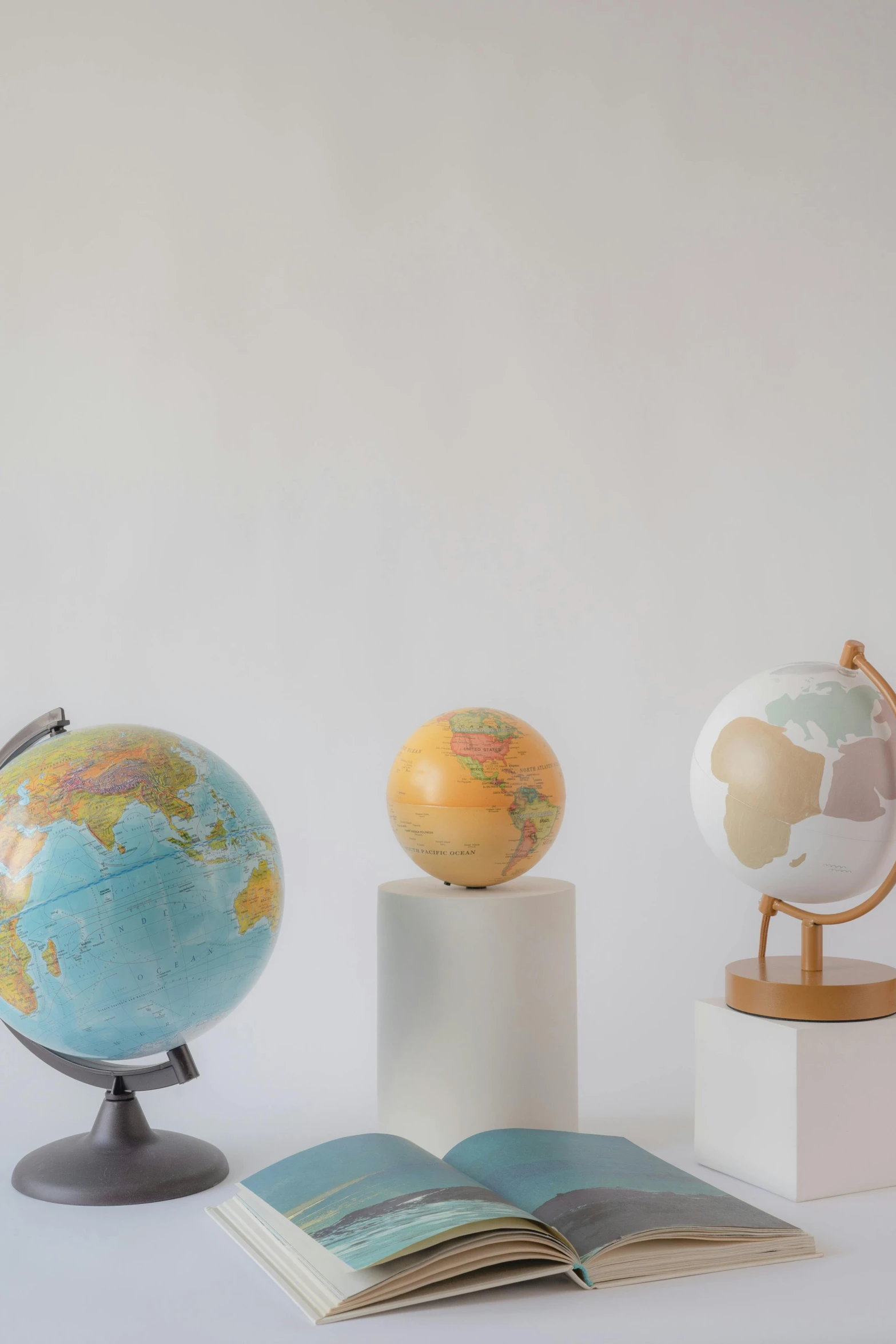 a book sitting on top of a table next to a globe