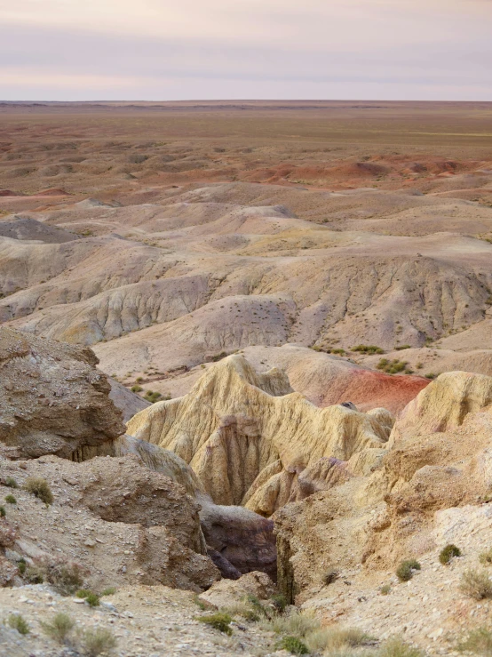 a view of a valley in the middle of a desert, a colorized photo, inspired by Slava Raškaj, between sedimentary deposits, large patches of plain colours, white, sandstone