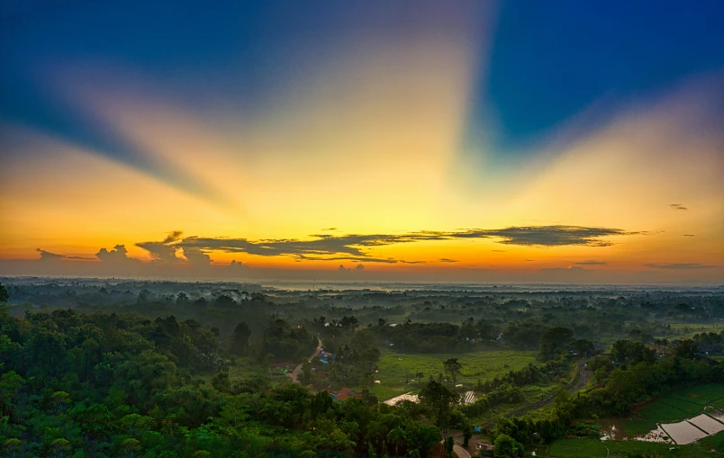 a view from the top of a hill at sunset, by Daniel Lieske, pexels contest winner, sumatraism, panorama view of the sky, bangladesh, bali, 8k resolution”