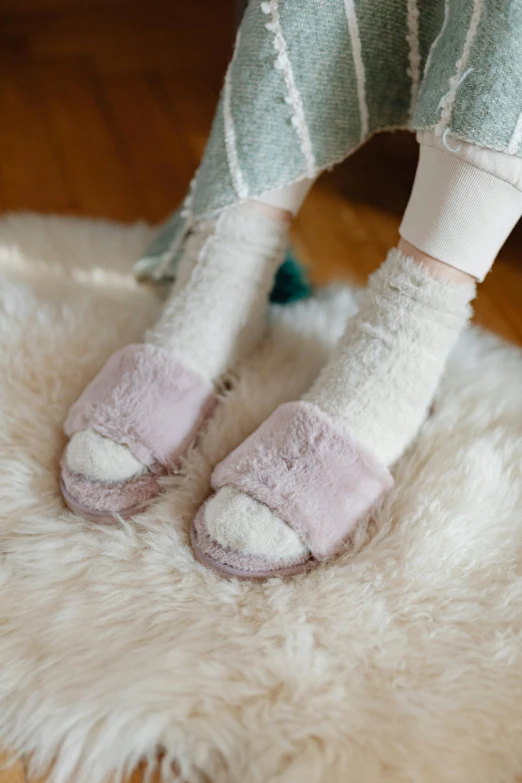 a close up of a person wearing slippers on a rug, by Eizan Kikukawa, unsplash, pastel clothing, mackenzie foy, purple fur, wearing kneesocks