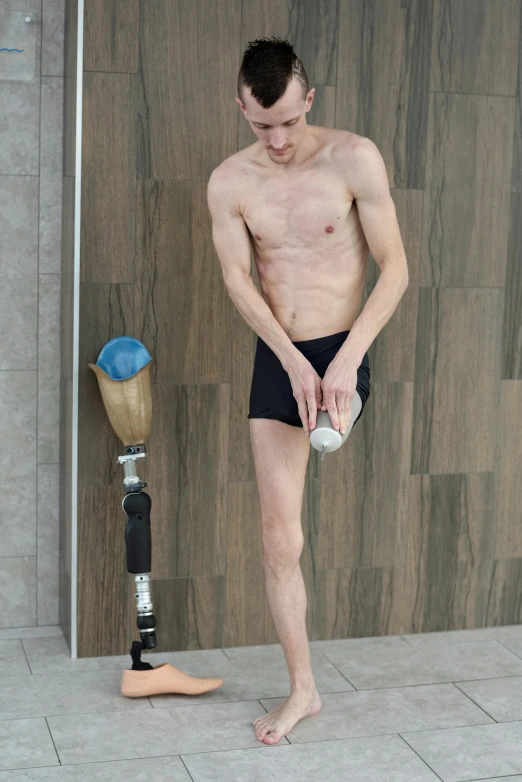 a man that is standing in front of a wall, by Jan Tengnagel, reddit, renaissance, artificial limbs, under a shower, pose 4 of 1 6, skinny caucasian young man