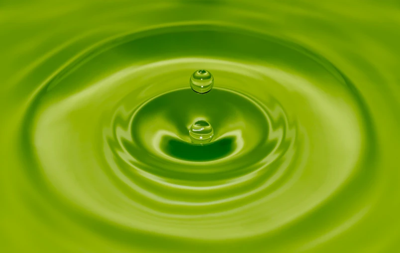 a green water drop in a pool of water, inspired by Art Green, pixabay, process art, square, organic rippling spirals, olive oil, 8 k octane comprehensive render