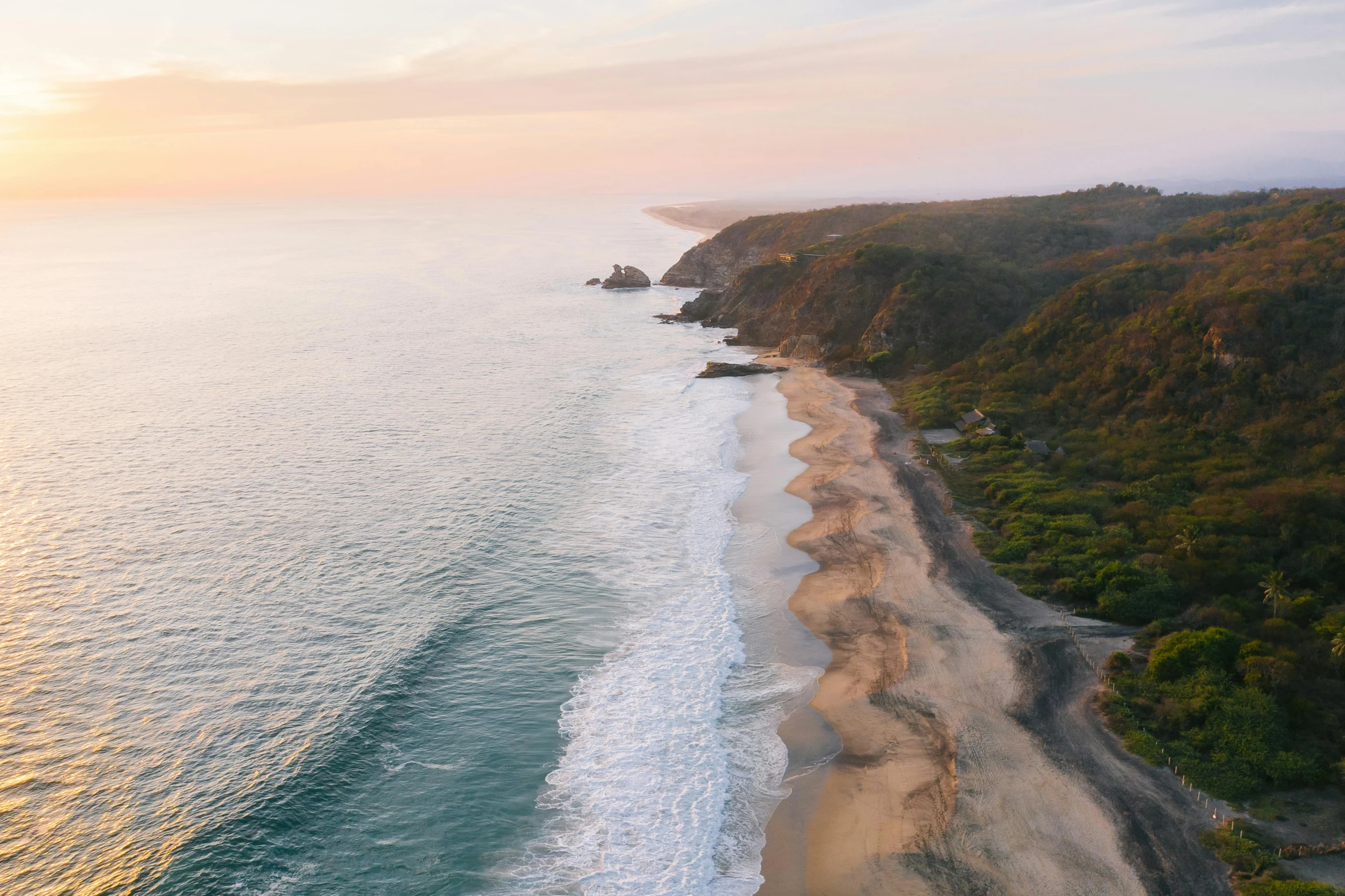 an aerial view of a beach at sunset, pexels contest winner, hills and ocean, grey, alana fletcher, long