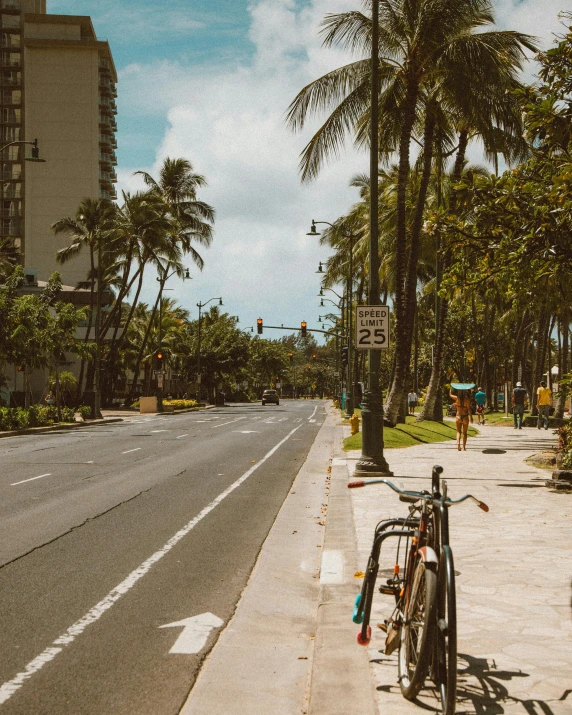 a bicycle parked on the side of a road, by Carey Morris, pexels contest winner, happening, waikiki beach, outdoors tropical cityscape, thumbnail, gif