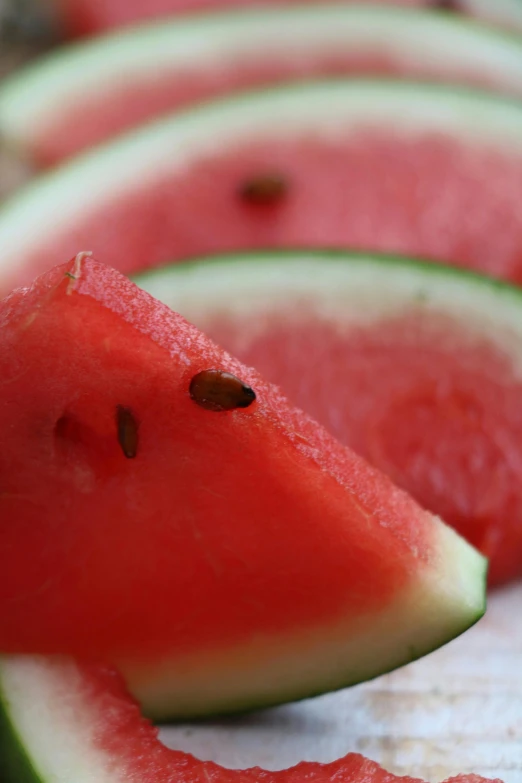 a close up of slices of watermelon on a table, by Ben Zoeller, 王琛, toward to the camera, had