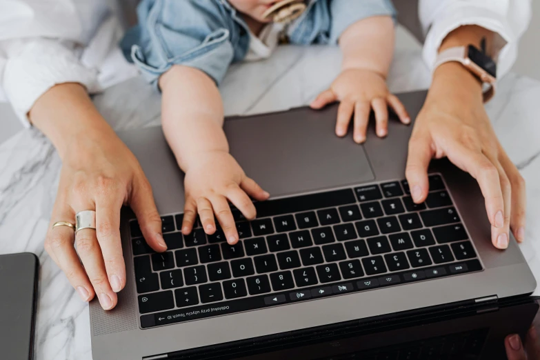 a woman holding a baby and typing on a laptop, pexels, worksafe. instagram photo, teaser, 1 2 9 7, panels