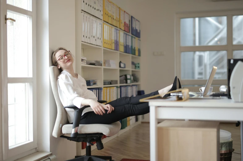 a woman that is sitting in a chair, in an office, laughingstock, high soles, high quality picture