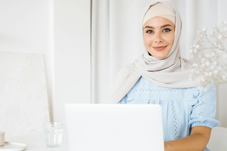 a woman sitting in front of a laptop computer, inspired by Maryam Hashemi, trending on pexels, hurufiyya, confident smirk, arab inspired, swedish, standing in class