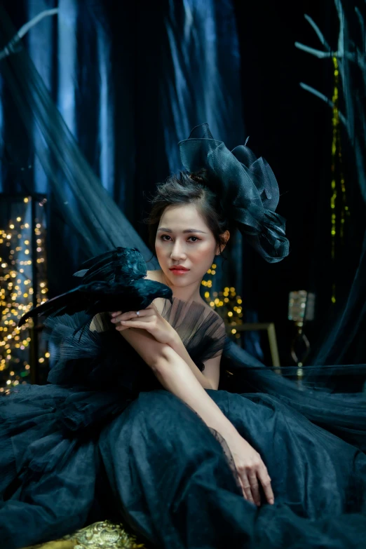 a woman in a black dress sitting on a chair, inspired by Chen Yifei, pexels contest winner, magical realism, there are birds on her head, 8 k movie still, vietnamese woman, queen of the night