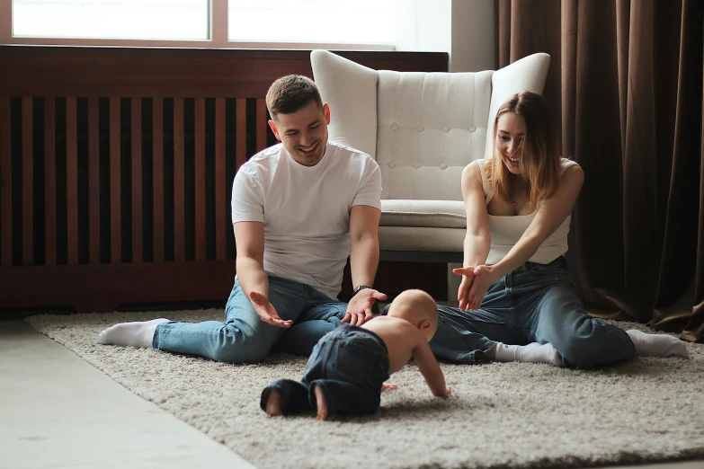 a man and woman sitting on the floor playing with a baby, a cartoon, pexels contest winner, hurufiyya, australian, relaxed posture, ( ultra realistic, nursing