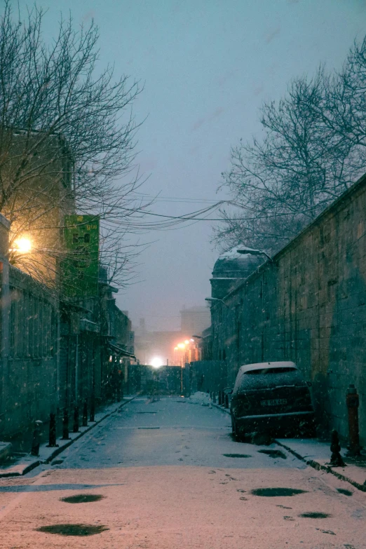 a car is parked on a snowy street, inspired by Elsa Bleda, old jeddah city alley, eerie light, samarkand, movie filmstill