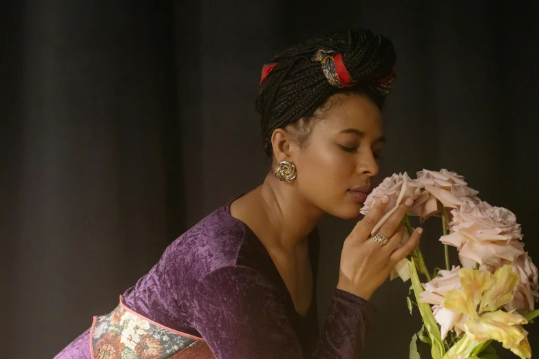 a woman in a purple dress smelling a flower, a portrait, inspired by Cecil Beaton, unsplash, mixed-race woman, film still from the movie, wearing pink floral chiton, recital