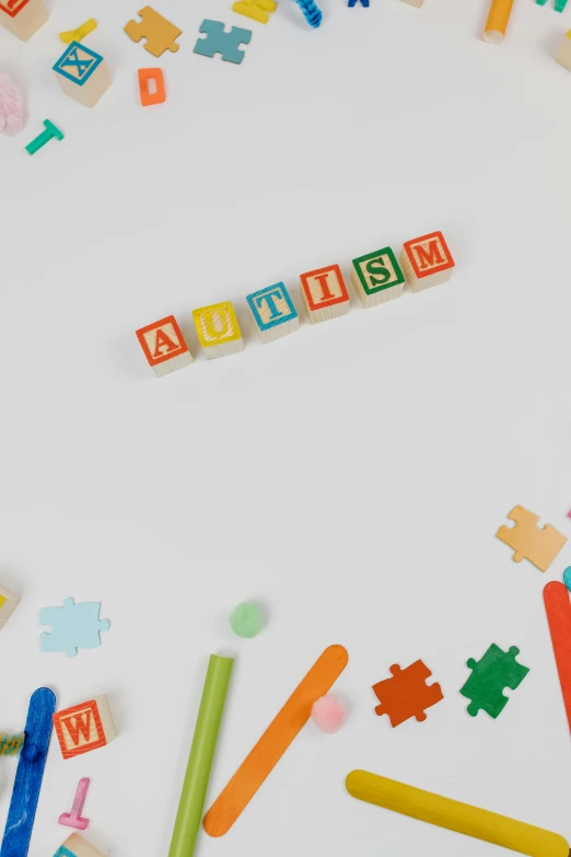 a white table topped with lots of wooden letters, a jigsaw puzzle, inspired by Augustyn Mirys, trending on pexels, made of lego, streamers, surreautistic, a still of a happy