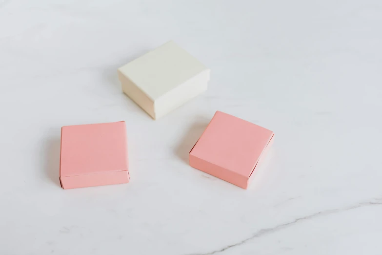 three pink and white boxes on a marble surface, private press, cream, small, 3 - piece, single