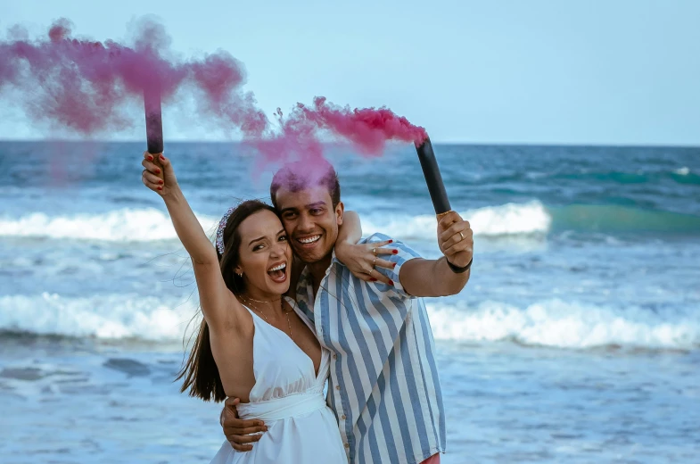 a man and woman standing next to each other on a beach, a colorized photo, pexels contest winner, happening, :6 smoke grenades, isabela moner, excited, pregnant