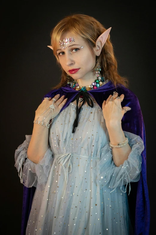 a woman dressed as a elf poses for a picture, a character portrait, featured on reddit, renaissance, princess of amethyst, close - up studio photo, fullbody photo, wearing! robes!! of silver