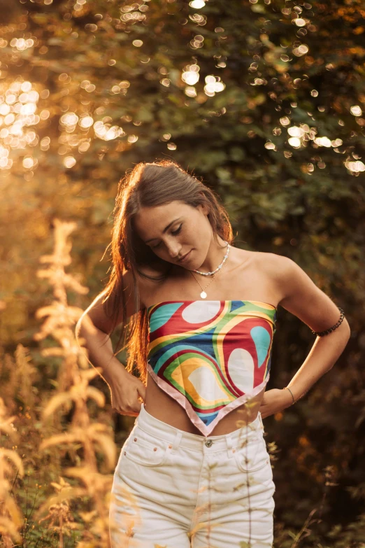 a woman standing in a field with her hands on her hips, an album cover, by Julia Pishtar, unsplash, colorful bandana, croptop, 5 0 0 px models, teenage girl