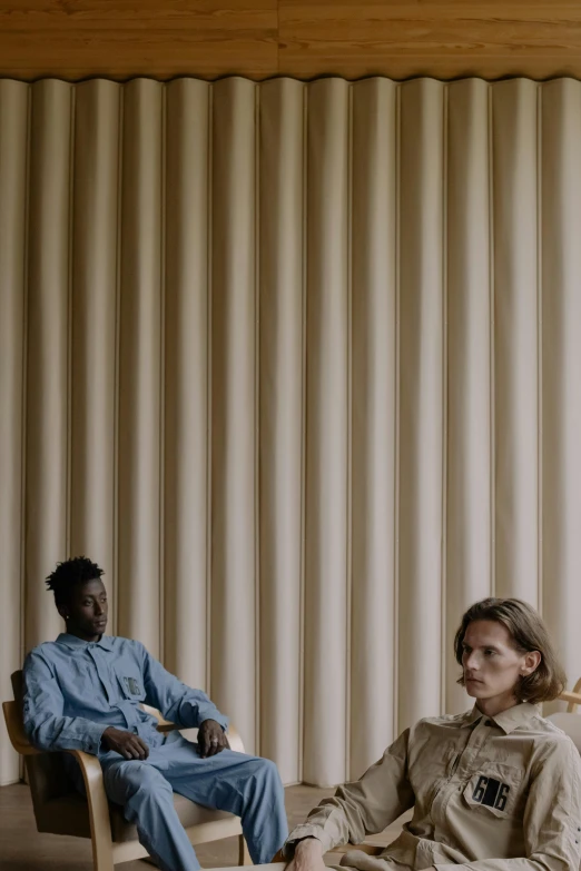 a couple of people that are sitting in a chair, an album cover, by Tobias Stimmer, trending on unsplash, purism, adut akech, corduroy, nordic, cinestill eastmancolor