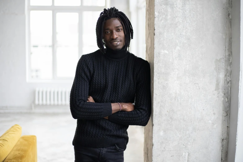 a man with dreadlocks standing in a room, a character portrait, by Nina Hamnett, pexels contest winner, black turtleneck, ( ( dark skin ) ), well-groomed model, guillaume tholly