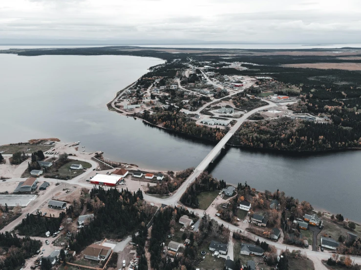 an aerial view of a large body of water, by Jaakko Mattila, pexels contest winner, hurufiyya, small town surrounding, grey, red lake, katey truhn