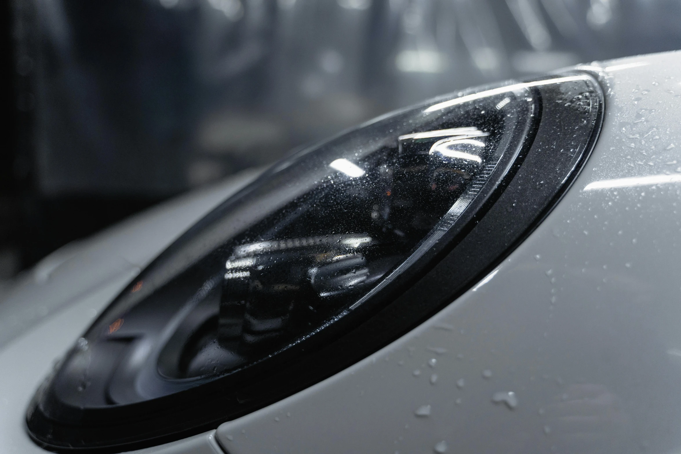 a close up of the headlight of a car, inspired by An Gyeon, pexels contest winner, photorealism, hyper realistic octane render 4k, white pearlescent, glossy from rain, upscaled to high resolution