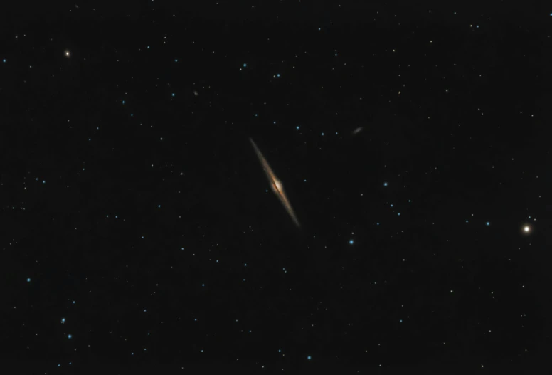 a close up of a galaxy with stars in the background, by Josh Bayer, hurufiyya, very elongated lines, heavy grainy picture, colour photograph, on black paper